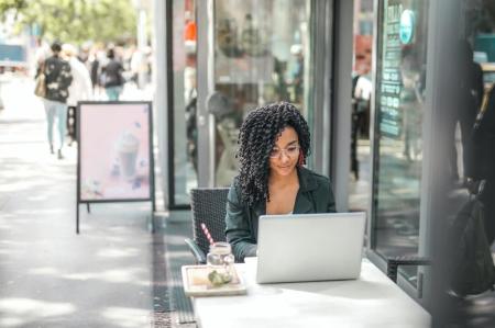 woman sitting outside on laptop